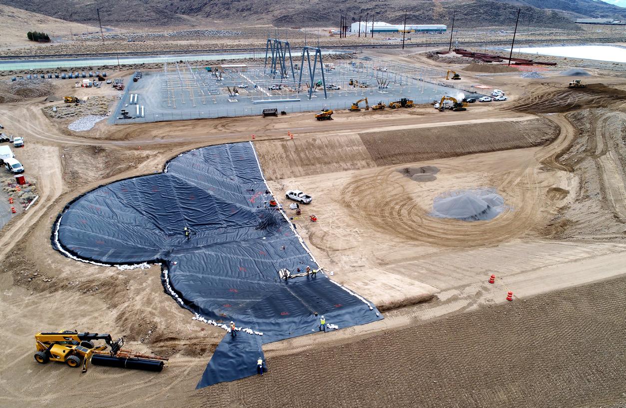 Lined retention basin under construction at a substation site