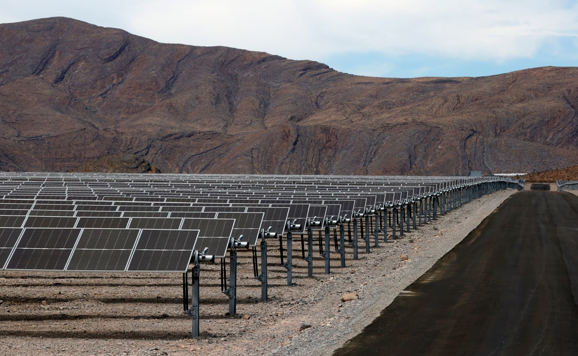 Panel rows and stabilized access road across the solar field.