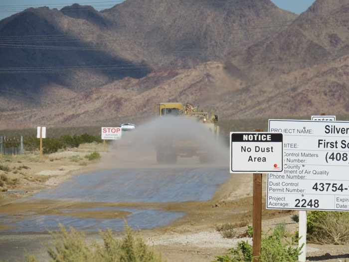 Water truck applying dust and sediment control on a permitted site
